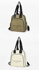 Vista frontale di zaini in nylon verde e beige con ampie tasche e manici neri