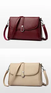 Detail view of lychee texture leather handbags in fuchsia and apricot with metal clasp