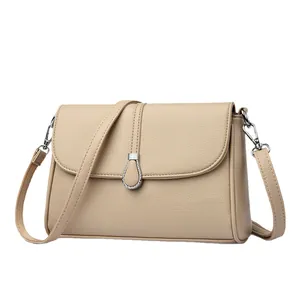Elegant apricot faux leather shoulder bag with pebbled texture and silver teardrop buckle