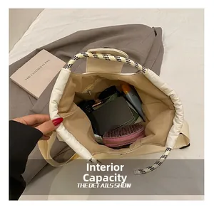 Detailed view of the spacious interior capacity and zipper pocket of the canvas tote bag