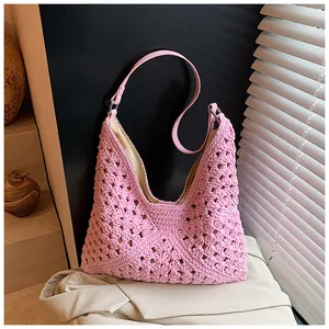 Close-up of pink crochet tote bag featuring intricate floral patterns and leather straps