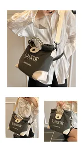 Detail of the chic canvas tote bag featuring adjustable wide strap and top handle