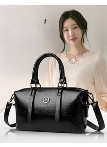 Detail of black pebbled leather texture and round kangaroo logo on fashion handbag
