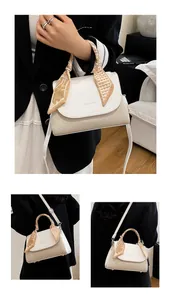 Detail of cream crossbody bag featuring a woven texture and silk scarf wrapped handle
