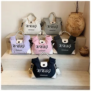 Group display of quilted tote bags in six colors with decorative woven rope handles