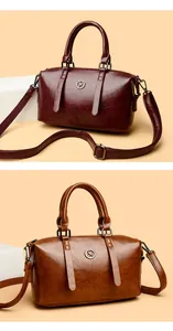 Detailed comparison of burgundy and caramel brown faux leather handbags with metal emblems