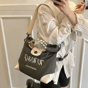 Contrast panel large tote bag with embroidery and checkered strap worn by model