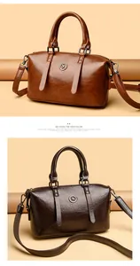 Detail of vintage soft leather handbags in brown and coffee with kangaroo metal logo