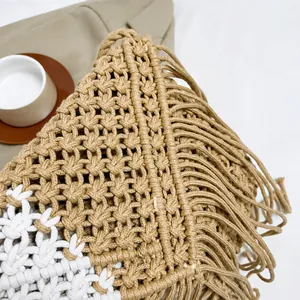 Macro detail of Bohemian woven bag showing intricate handmade texture and tassels