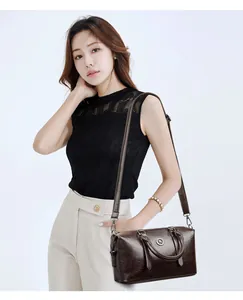 Detail of dark brown vintage Boston bag showing wrinkled leather texture and handle