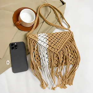 Close-up of woven net texture and tassel details on Bohemian straw crossbody bag