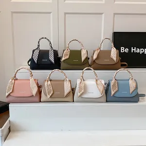 Fashion handbags in seven colors with decorative silk scarves and front text detail