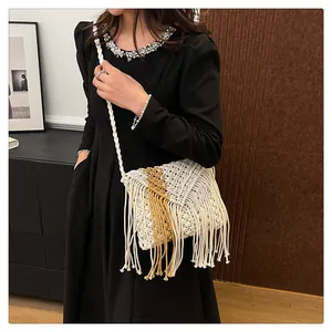 Detail of bohemian macramé shoulder bag with tassels and bicolor woven design