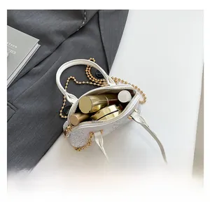 Top view of white shell bag interior with lipstick and cosmetics showing storage capacity