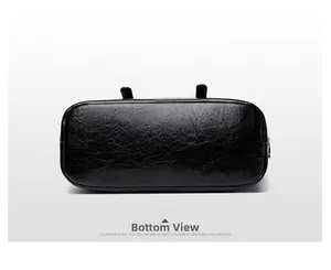 Detailed bottom view showing oval base and precise stitching of black leather handbag