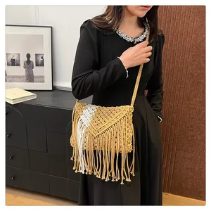 Detail of bohemian straw bag with ginger yellow fringe and woven V-pattern texture