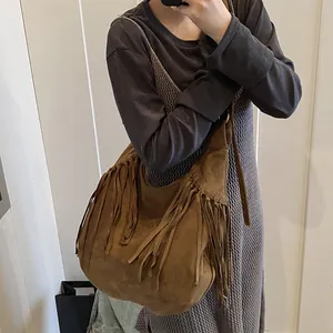 Brown suede fringed hobo bag for women with bohemian tassels and adjustable shoulder strap