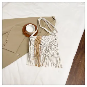Detailed macro view of woven macrame texture and long fringe on the bohemian crossbody bag