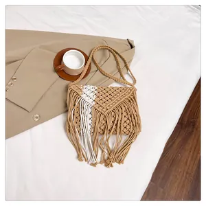 Detailed macro view of bohemian handmade macrame straw bag with fringe and woven texture