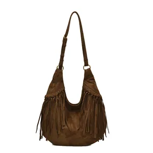 Retro brown suede crescent shoulder bag featuring bohemian long fringe tassels and strap