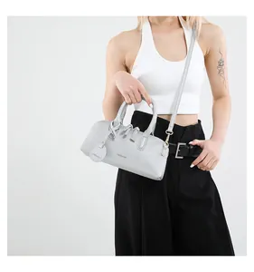 Detail view of the silver textured tote bag with FASHION logo and detachable strap