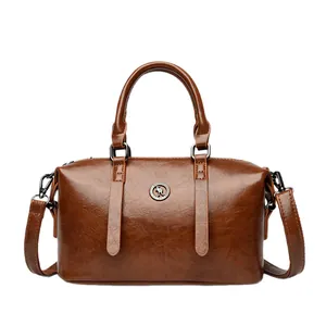 Brown soft leather Boston bag with double handles and kangaroo logo on white background