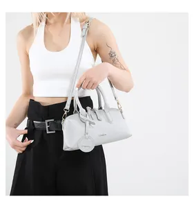 Detail of silver grey lychee textured tote bag with gold hardware and fashion embossing