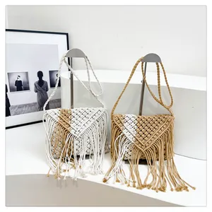 Detail view of bohemian handmade woven straw bags featuring geometric tassel accents