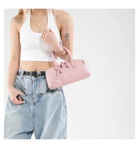Detail of pink lychee leather tote bag with FASHION lettering and round decorative tag