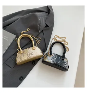 Detail view of mini sequin shell bags in gold and black with metallic chain straps