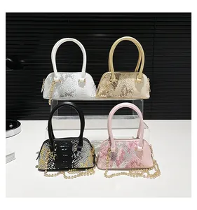 Macro shot of stylish sequin shell bags in four colors with snake texture and gold chains