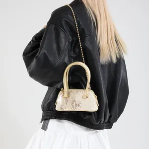 Chic champagne sequin shell bag with golden chain strap for stylish evening commutes