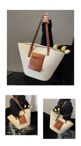 Détail d'un sac cabas tissé beige avec anses en cuir marron et poche décorative