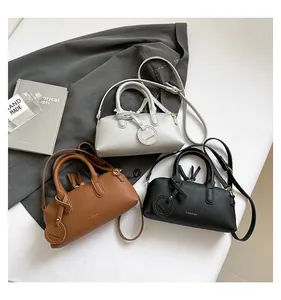 Detailed macro of pebble-grain leather tote bags in silver, brown and black colors