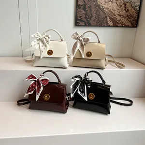 Four vintage glossy PU leather handbags with decorative silk scarves and metal locks