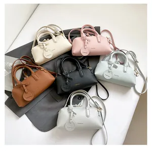Top view of lychee pattern leather Boston bags in six colors with gold hardware