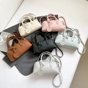 Chic Boston barrel bags in six colors featuring pebble grain leather and fashion straps
