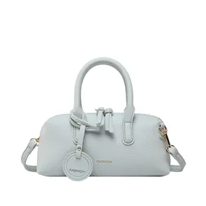 Minimalist light blue Boston handbag in pebbled leather with Fashion logo print