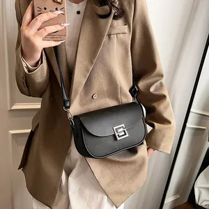 Minimalist black saddle shoulder bag with litchi texture and silver square buckle