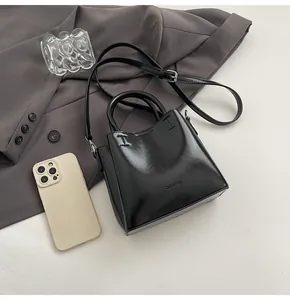 Top view of black polished crossbody bag with CLEAROK branding and adjustable shoulder strap