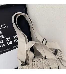 Detail of durable canvas tote bag shoulder strap with high-density stitching and metal buckle