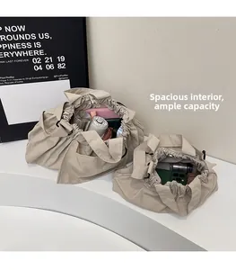 Detailed interior storage view of two beige drawstring tote bags showing large capacity