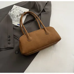 Top-down view of brown lychee leather bowling bag with dual handles and smooth zipper