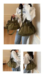 Detail of army green canvas bucket bag featuring pleated design and adjustable straps