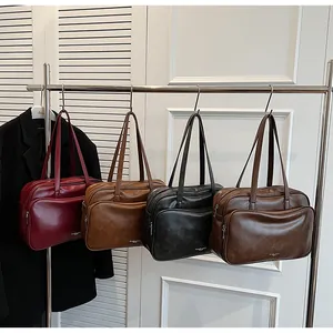 Detailed row of leather Boston handbags in burgundy, tan, black and dark coffee colors