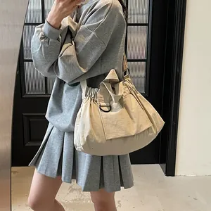 Minimalist beige nylon tote bag for women with wide shoulder strap and puffer texture