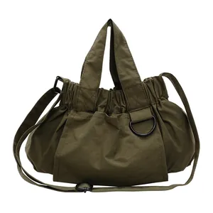 Army green nylon pleated tote bag with adjustable shoulder strap and matte hardware