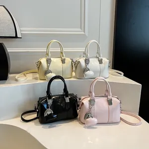 Fashionable Boston handbag in multiple colors with heart charm and shoulder strap
