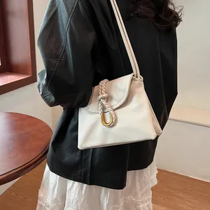 Chic white faux leather shoulder bag with woven rope detail and gold U-shaped buckle