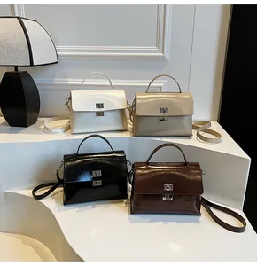 Detailed display of soft leather crossbody bags in four colors with metal turn-lock closures
